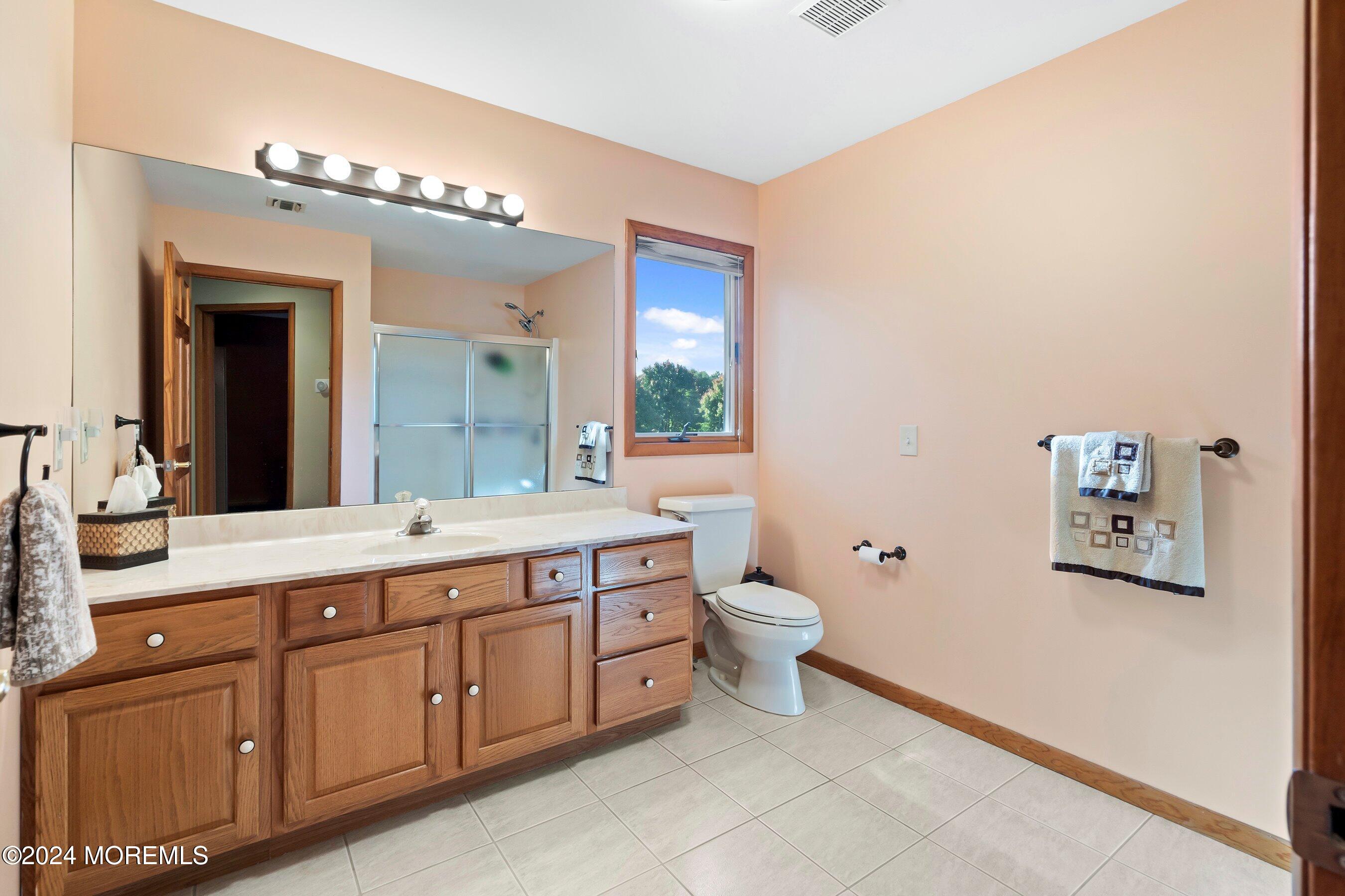 742 Rabbit Run Brick, NJ 08724 - Photo 39 of 51 a spacious bathroom with a granite countertop sink mirror vanity and toilet