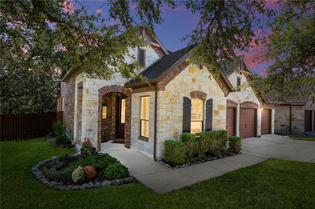 a front view of a house with garden