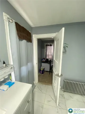 a view of utility room and bedroom