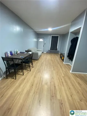 a living room with a table and wooden floor