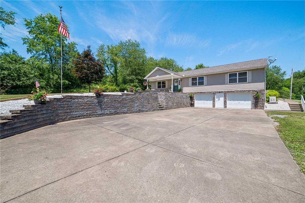 452 Upper Service Road Hookstown, PA 15050 - Photo 1 of 41 a front view of a house with a yard and garage