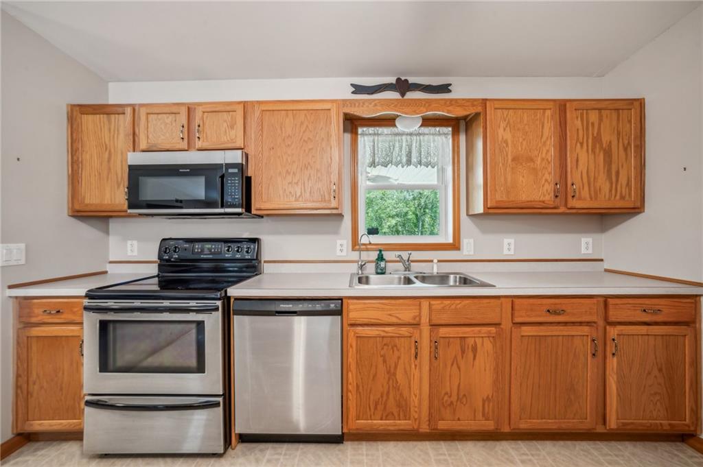 452 Upper Service Road Hookstown, PA 15050 - Photo 26 of 41 a kitchen with granite countertop wooden cabinets stainless steel appliances and a window