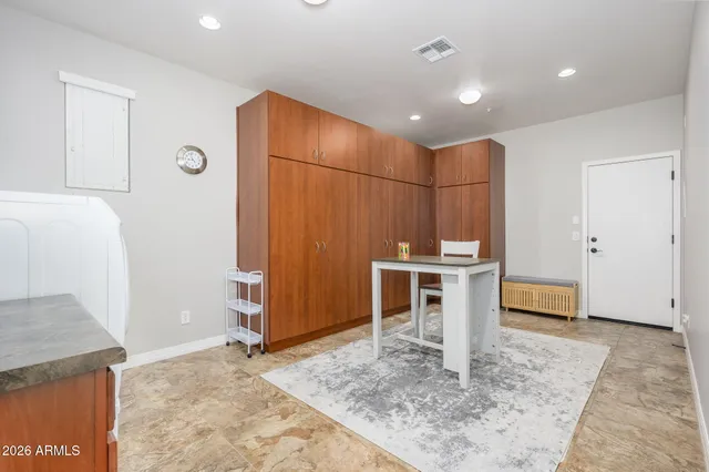 a bathroom with a granite countertop sink a mirror and a bathtub