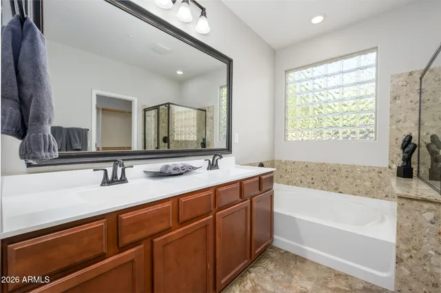 a view of a hallway with closet and a bathroom