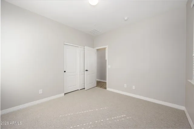 a front view of a house with a garden and yard