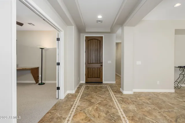 a view of a room with gym equipment and a chandelier
