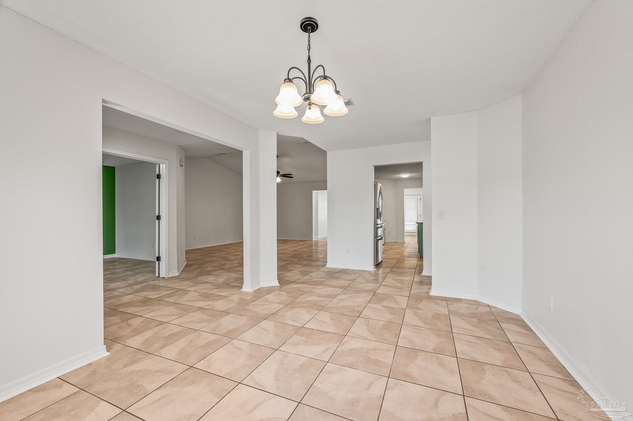 4263 Crosswind Drive Milton, FL 32583 - Photo 11 of 43 a view of an empty room with window and chandelier