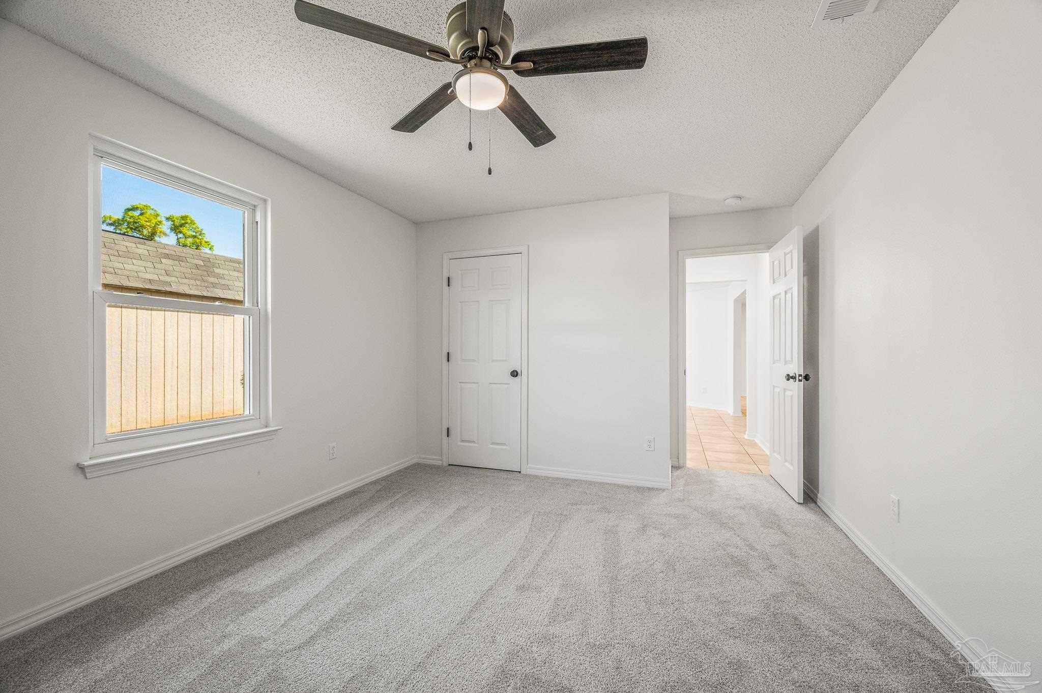 4263 Crosswind Drive Milton, FL 32583 - Photo 17 of 43 an empty room with windows and fan