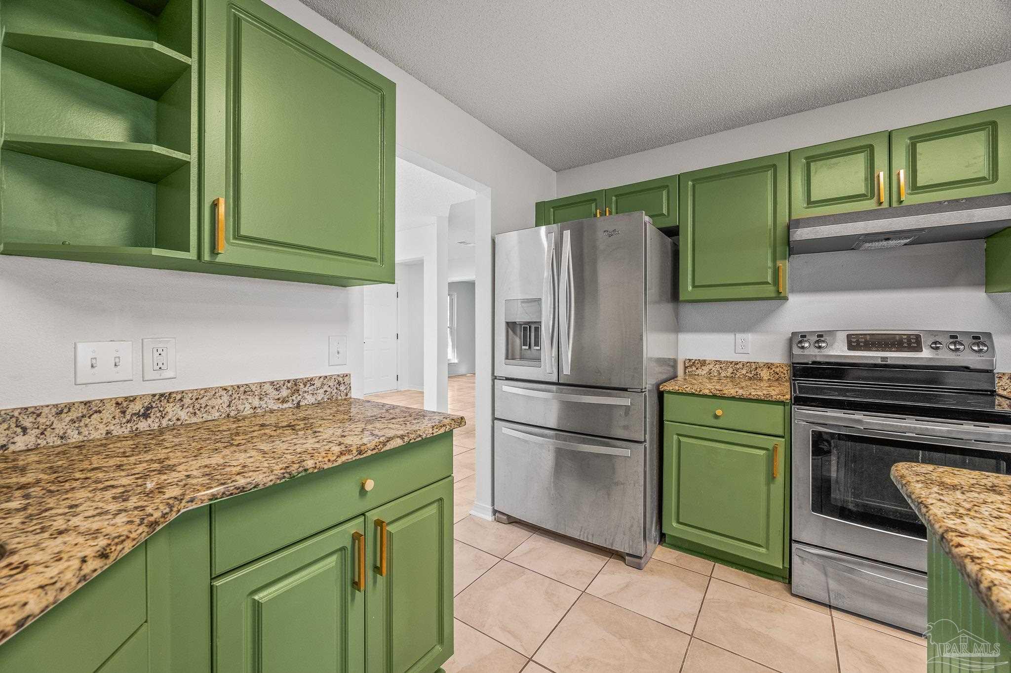 4263 Crosswind Drive Milton, FL 32583 - Photo 20 of 43 a kitchen with a refrigerator and a sink