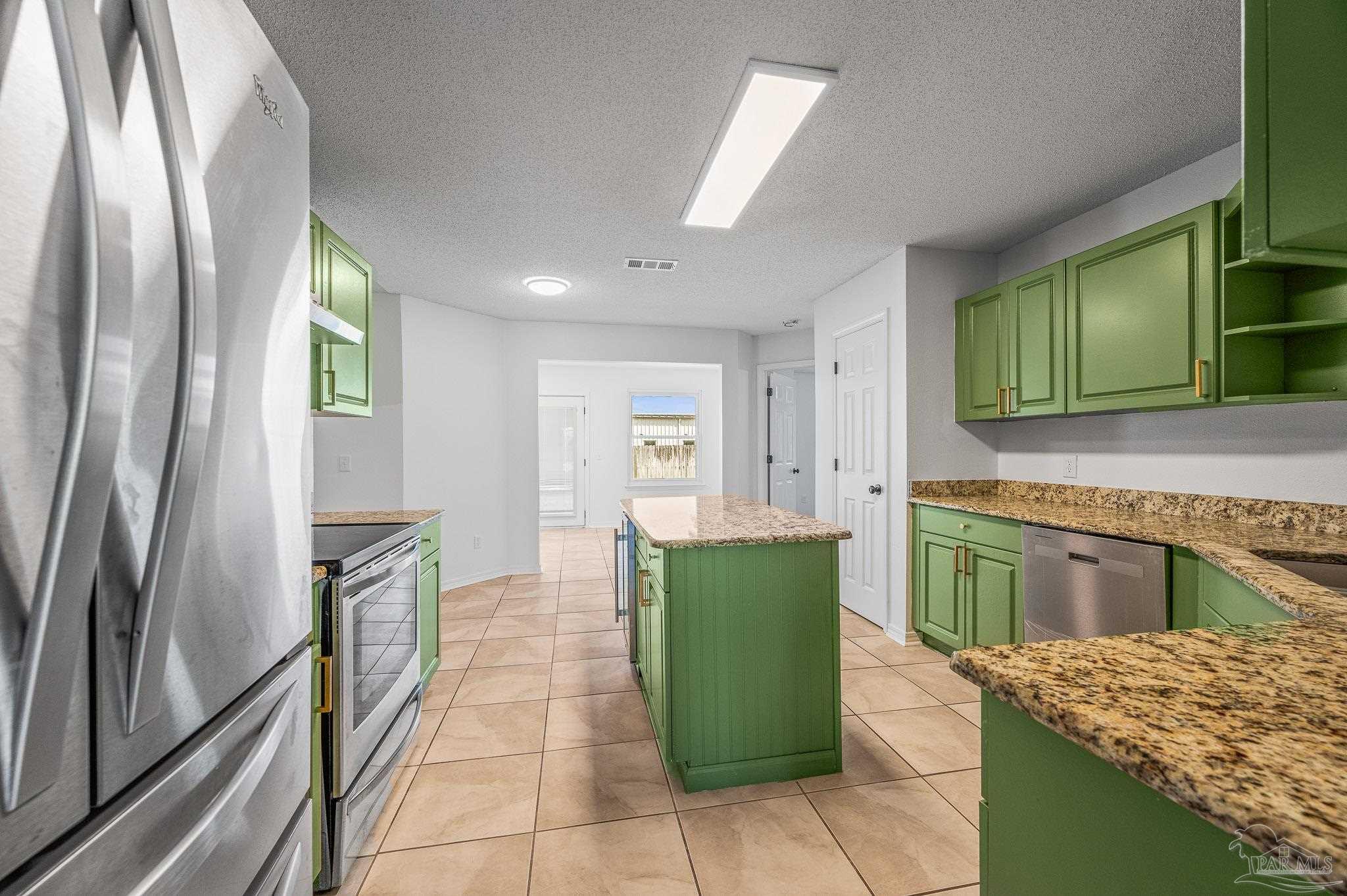 4263 Crosswind Drive Milton, FL 32583 - Photo 21 of 43 a kitchen with a refrigerator sink and microwave