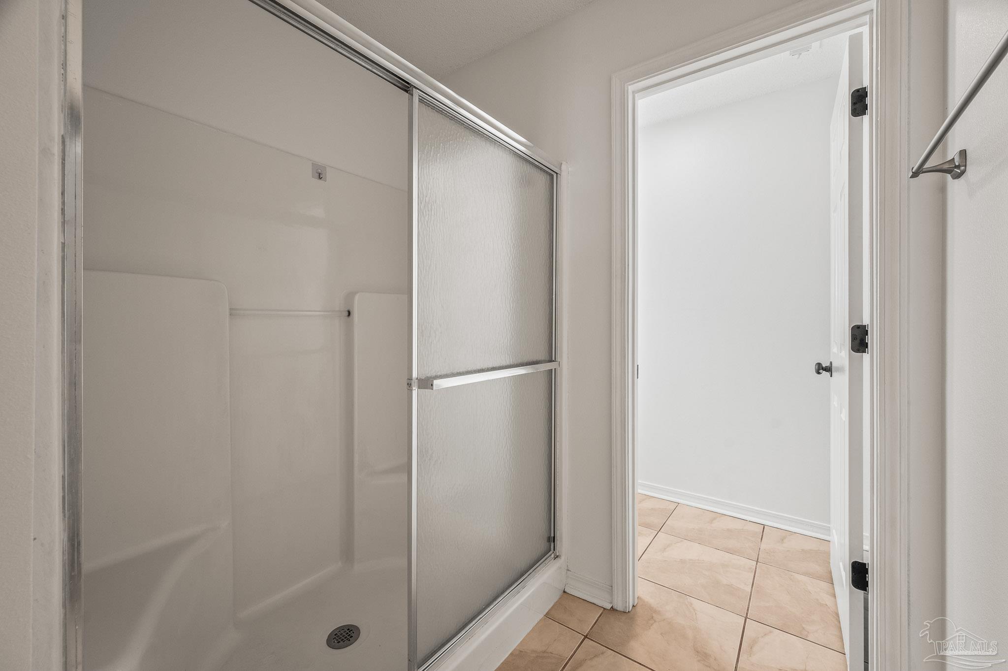 4263 Crosswind Drive Milton, FL 32583 - Photo 29 of 43 a bathroom with a glass shower door