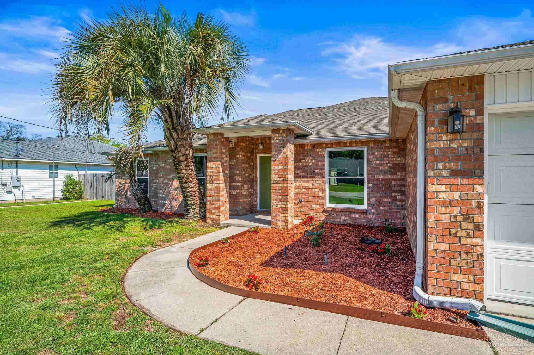 4263 Crosswind Drive Milton, FL 32583 - Photo 3 of 43 front view of a house with a yard