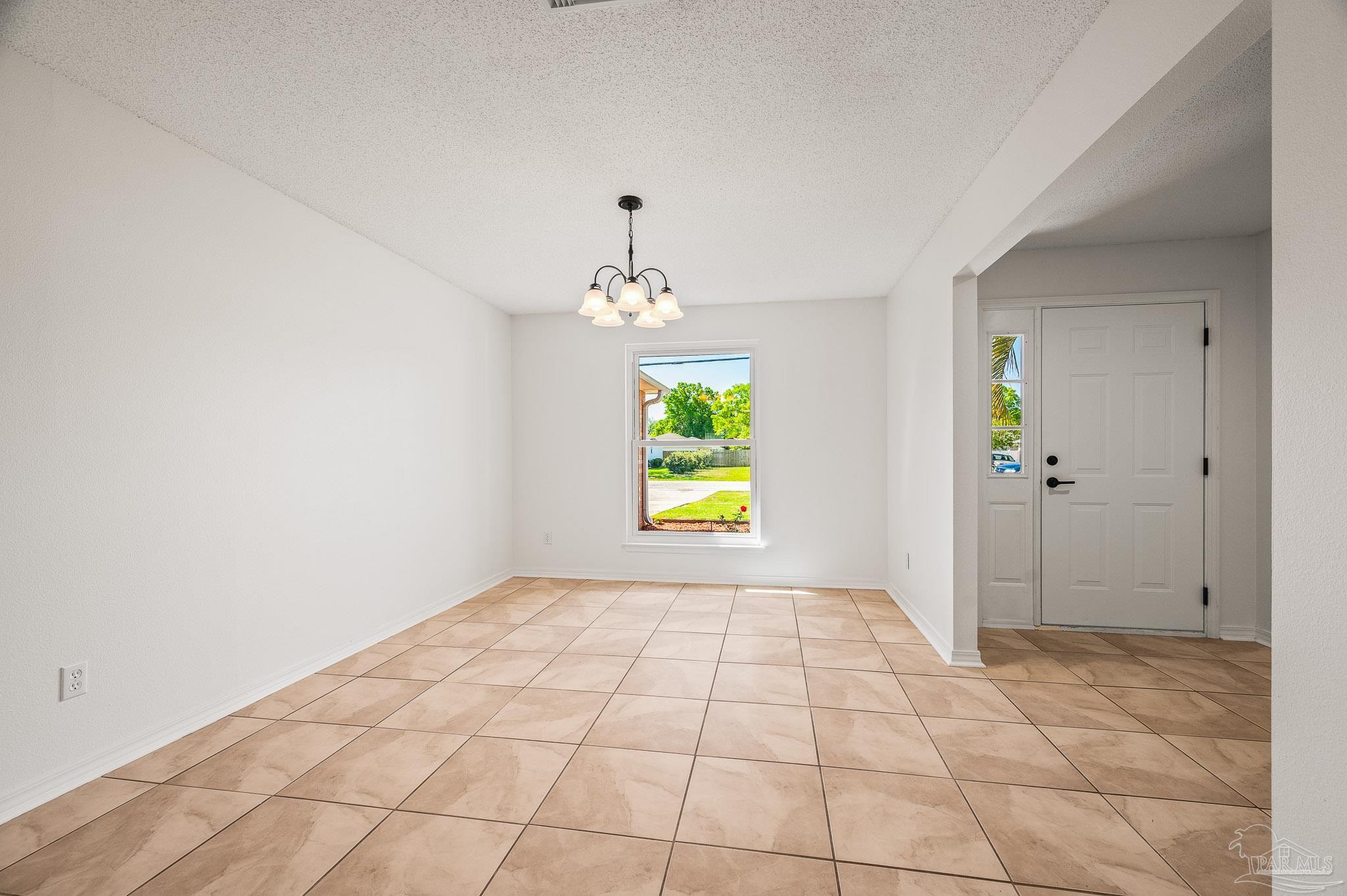 4263 Crosswind Drive Milton, FL 32583 - Photo 8 of 43 wooden floor in an empty room with a window