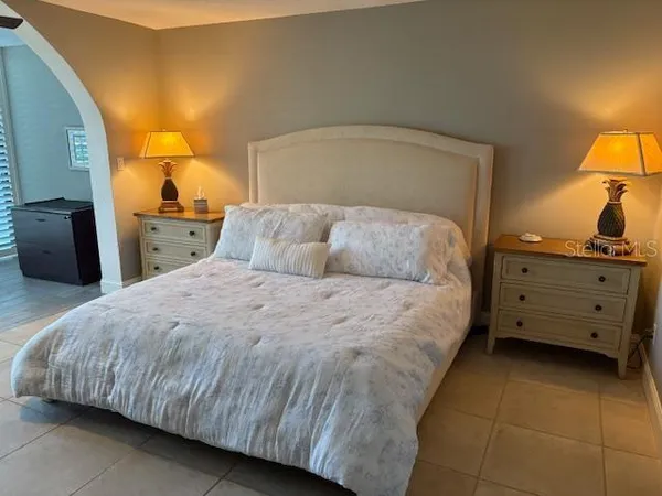 a bedroom with a bed and a lamp