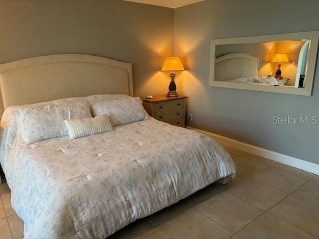 737 Bayport Way, Unit D Longboat Key, FL 34228 - Photo 6 of 31 a bed sitting in a bedroom next to a window