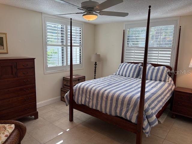 737 Bayport Way, Unit D Longboat Key, FL 34228 - Photo 7 of 31 a bedroom with a bed and a window