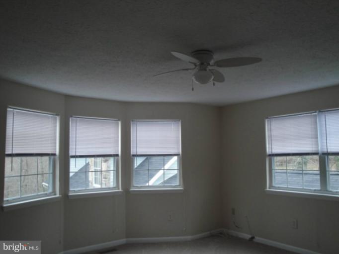 4380 Plum Point Road Huntingtown, MD 20639 - Photo 13 of 28 an empty room with windows and closet