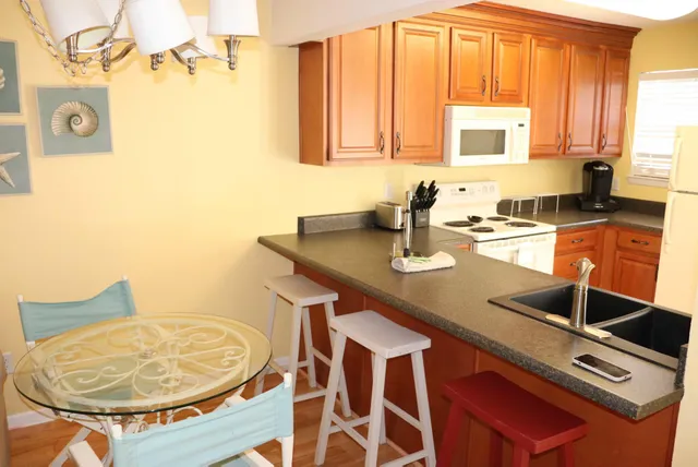 a kitchen with a sink cabinets and window