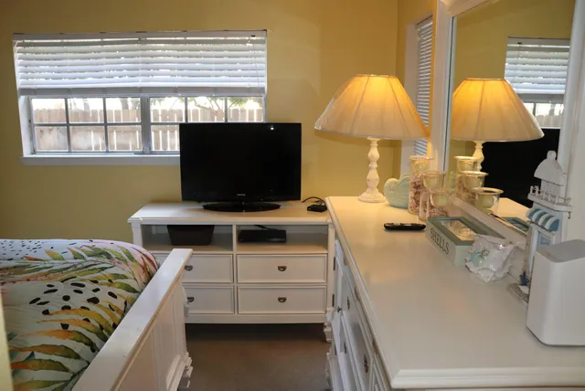 a bed room with two beds and a window