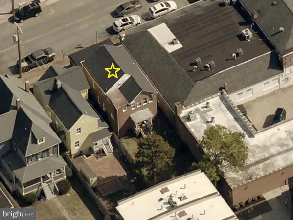 an aerial view of multiple houses with yard