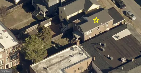 an aerial view of a residential apartment building with a yard