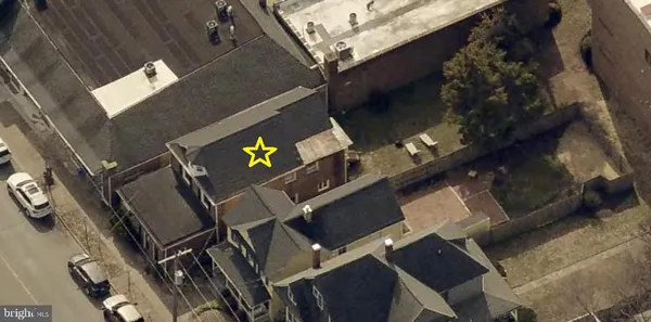 an aerial view of a residential apartment building with a yard