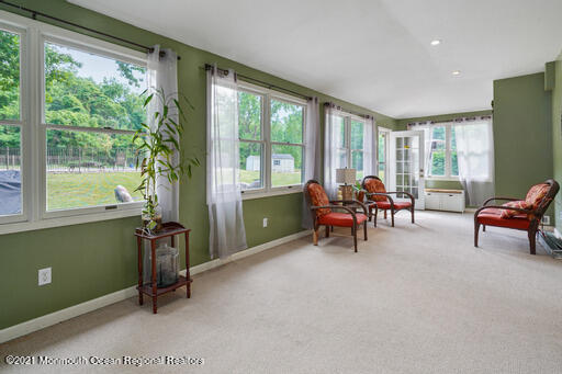 77 Tennent Road Morganville, NJ 07751 - Photo 14 of 37 a living room with furniture and a large window