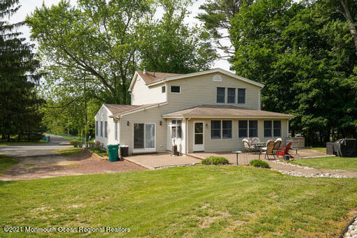 77 Tennent Road Morganville, NJ 07751 - Photo 22 of 37 a front view of a house with garden