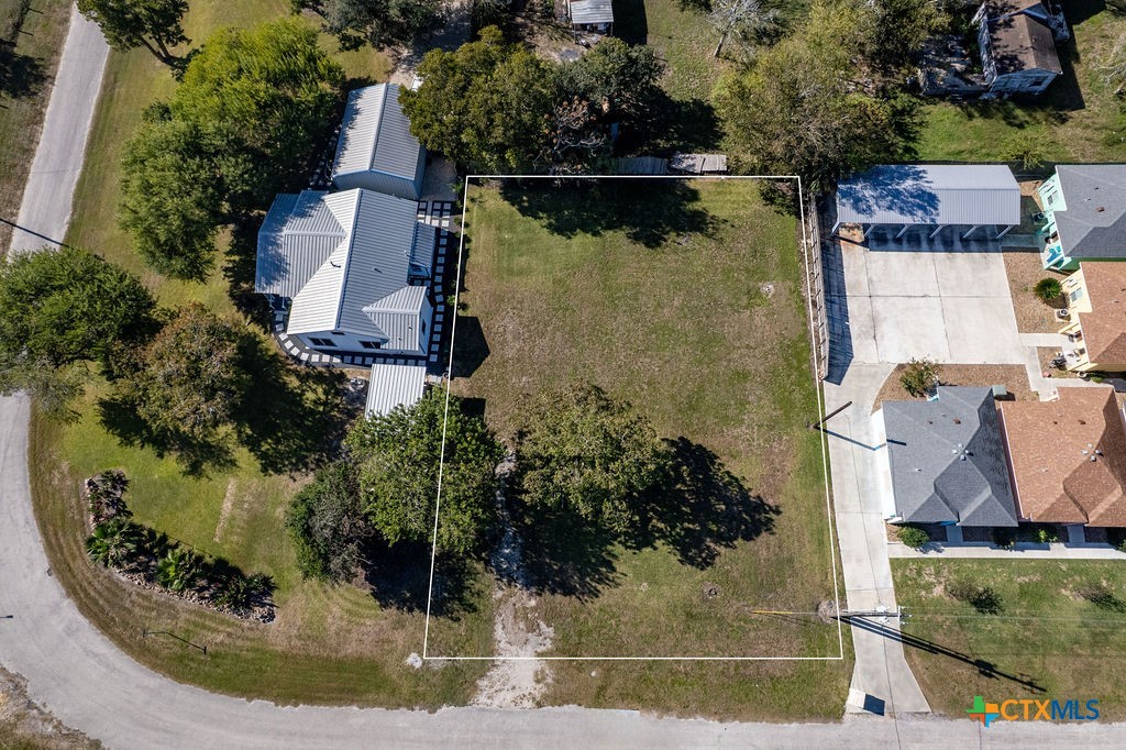 Tbd Commerce Street Port Lavaca, TX 77979 - Photo 5 of 12 an aerial view of a house with a yard and large trees