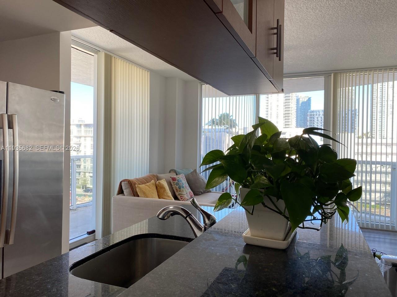 601 Northeast 23rd Street, Unit 706 Miami, FL 33137 - Photo 17 of 25 a living room with furniture and a potted plant
