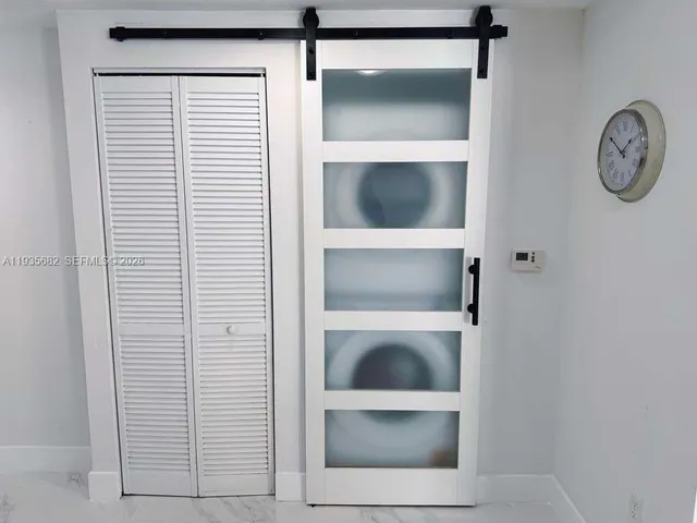 a view of a hallway with washer and dryer