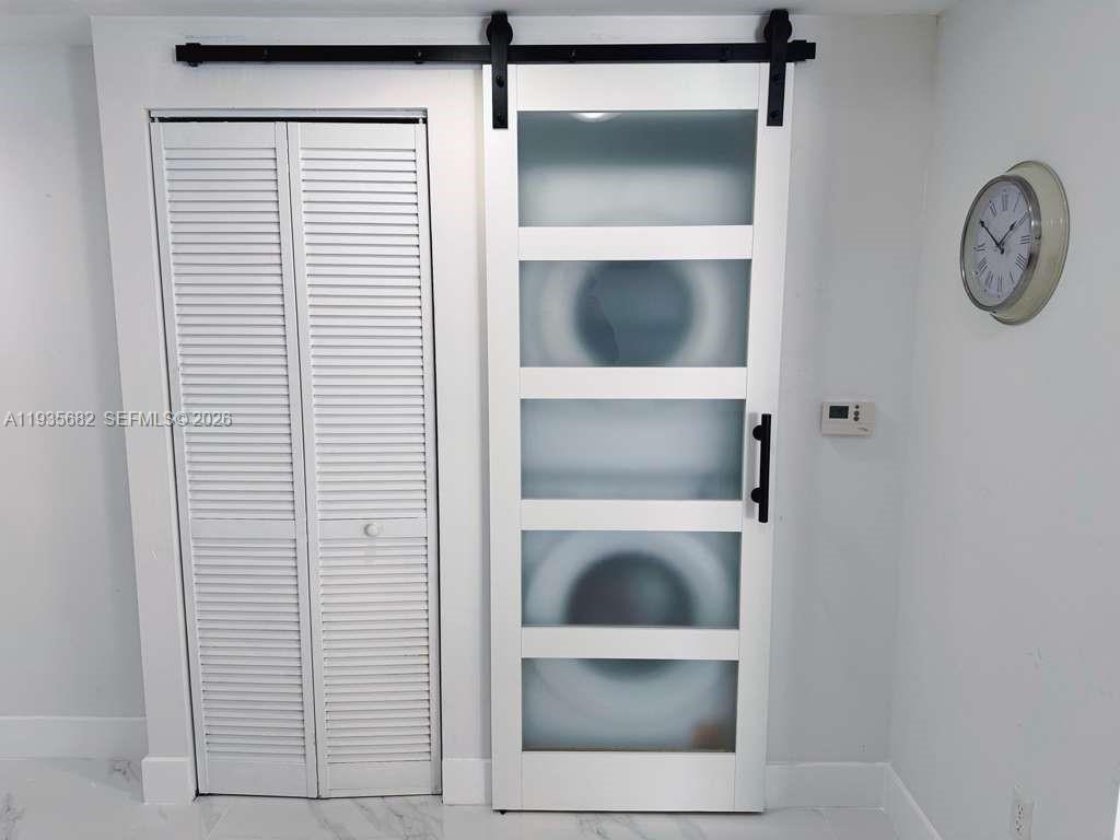 601 Northeast 23rd Street, Unit 706 Miami, FL 33137 - Photo 25 of 25 a view of a hallway with washer and dryer