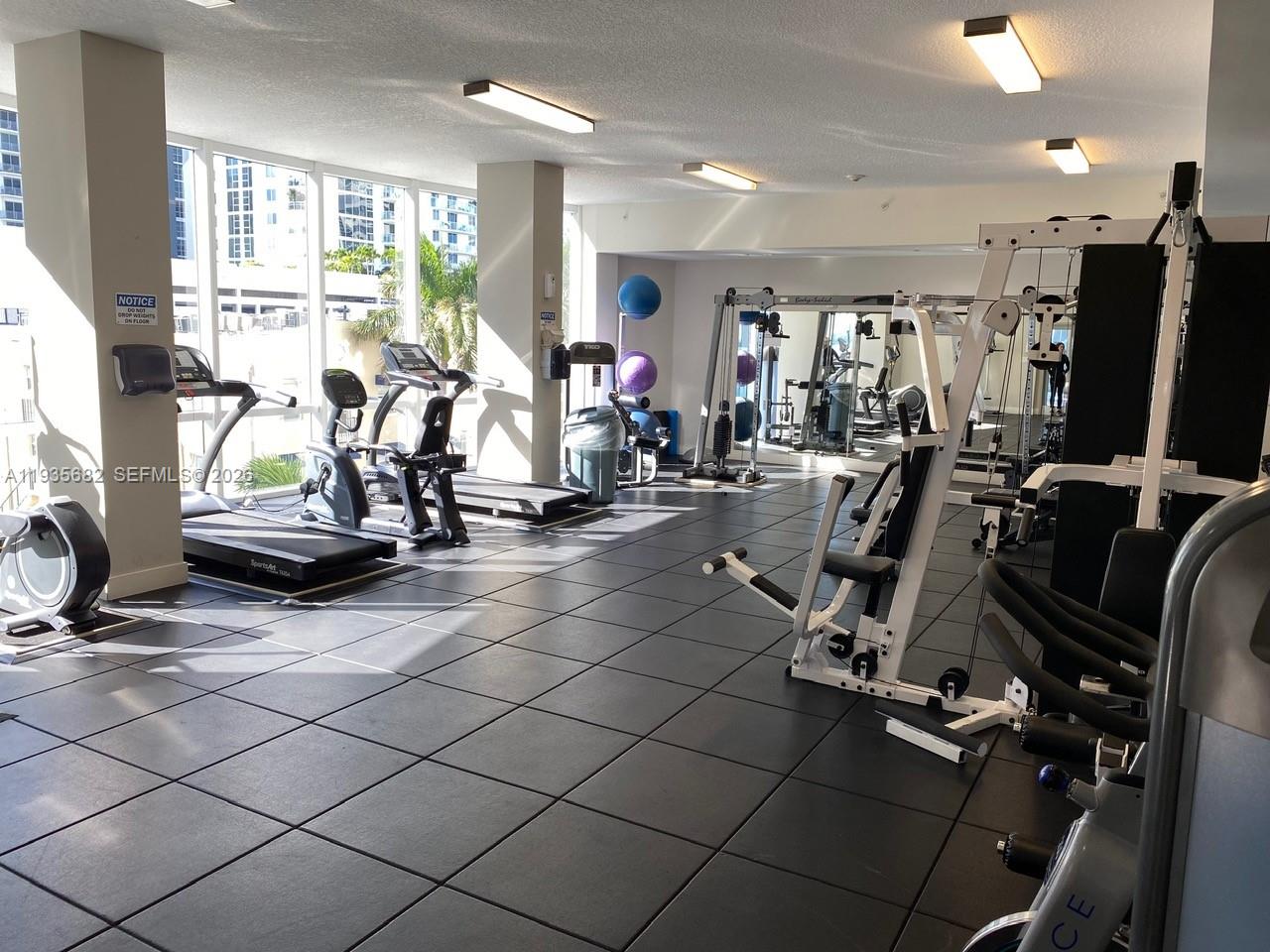 601 Northeast 23rd Street, Unit 706 Miami, FL 33137 - Photo 4 of 25 a view of a room with gym equipment