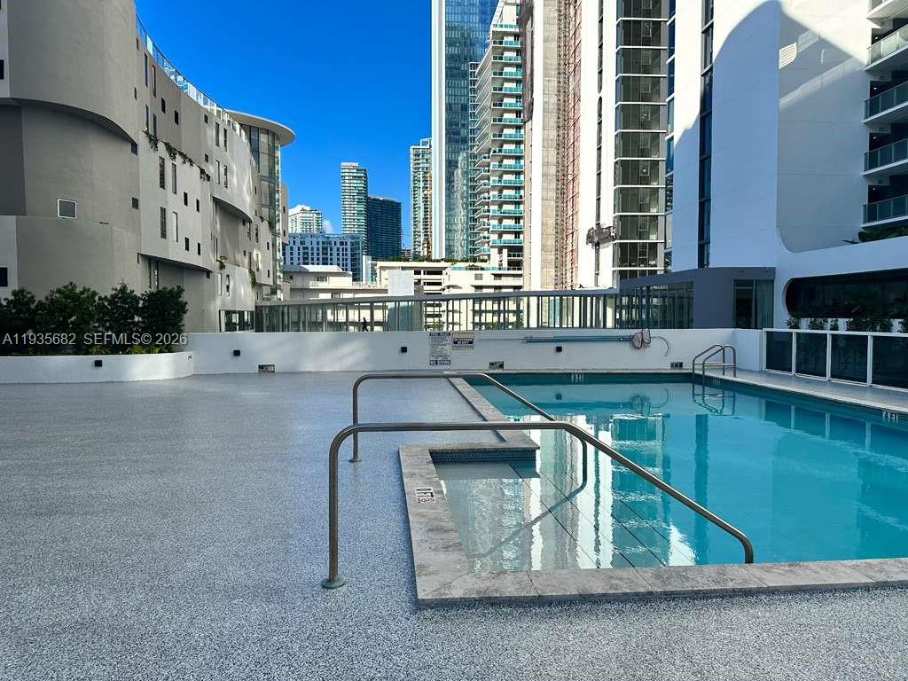 601 Northeast 23rd Street, Unit 706 Miami, FL 33137 - Photo 5 of 25 a kitchen with a sink and cabinets
