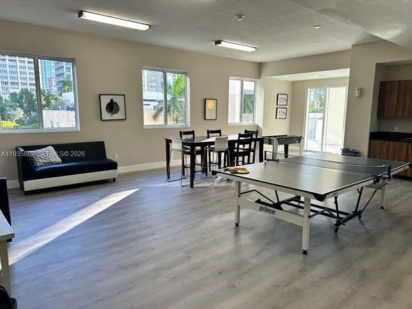 a living room with furniture a wooden floor and a window