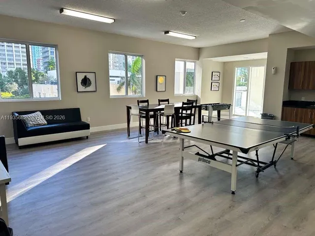 a living room with furniture a wooden floor and a window