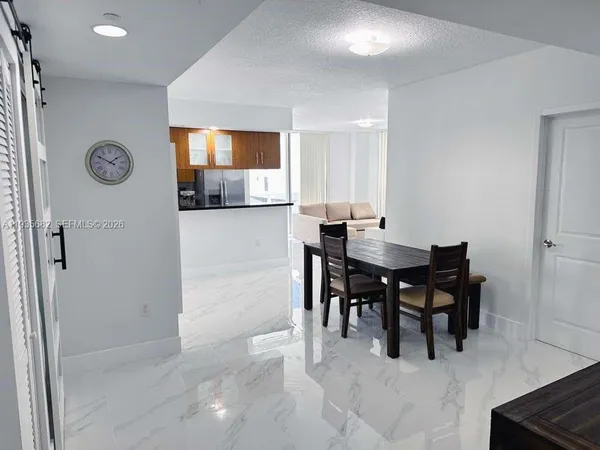 a dining room with furniture and window