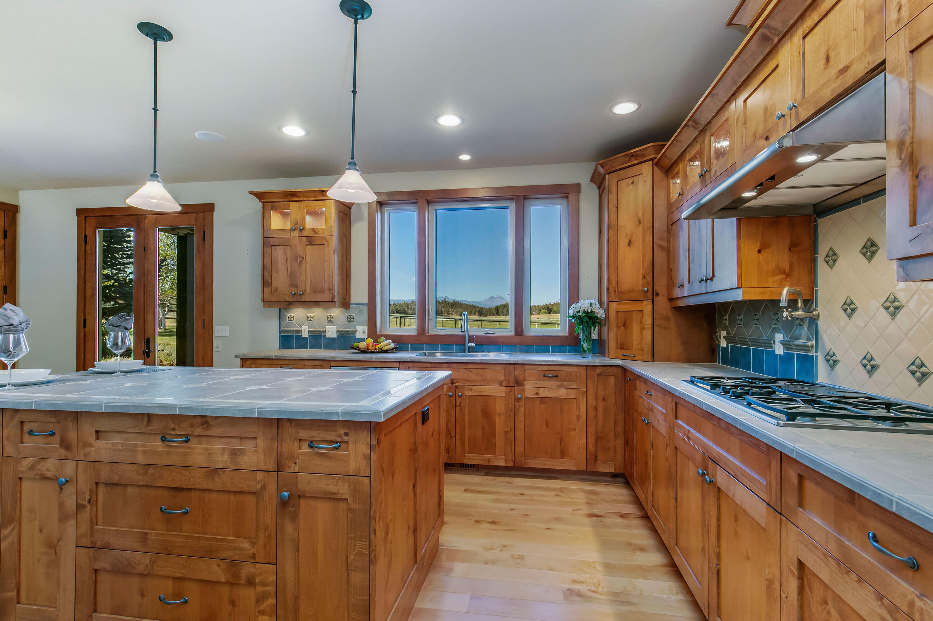 19460 Dayton Road Bend, OR 97703 - Photo 7 of 34 a kitchen with stainless steel appliances granite countertop a sink a stove and a wooden floors