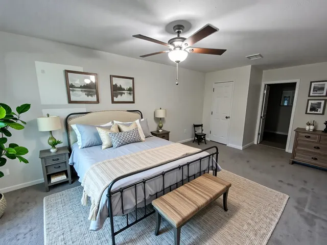a bedroom with furniture and wooden floor