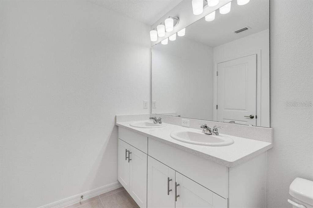 3035 Novara Lane Lakewood Ranch, FL 34211 - Photo 12 of 18 a bathroom with a sink and a mirror