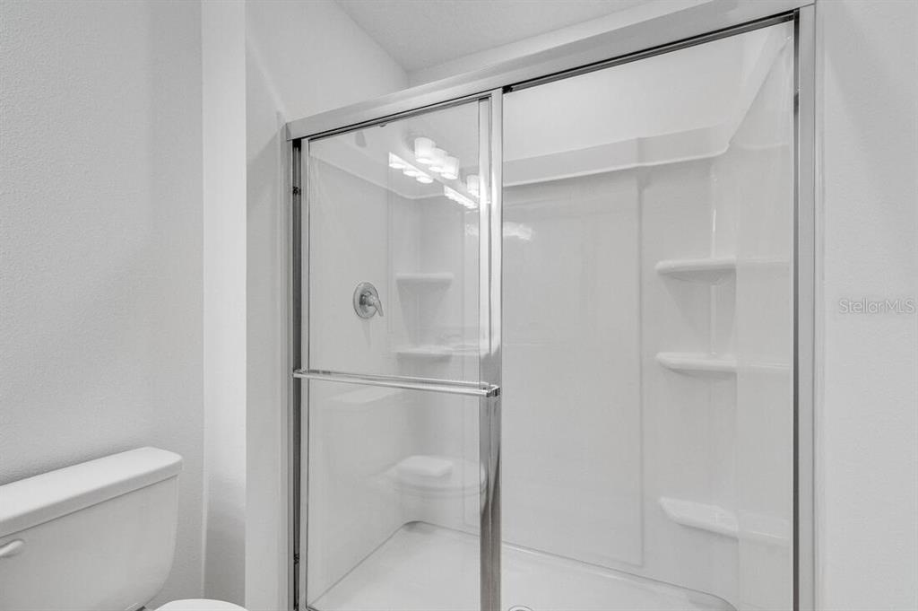 3035 Novara Lane Lakewood Ranch, FL 34211 - Photo 13 of 18 a bathroom that has a glass shower door