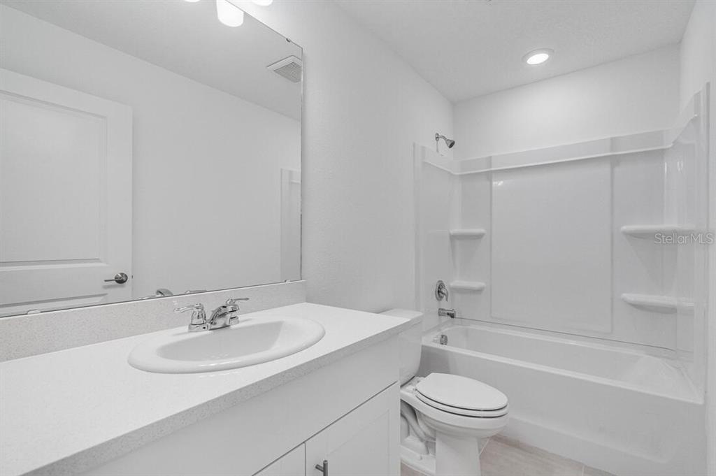 3035 Novara Lane Lakewood Ranch, FL 34211 - Photo 18 of 18 a bathroom with a sink toilet and a bathtub