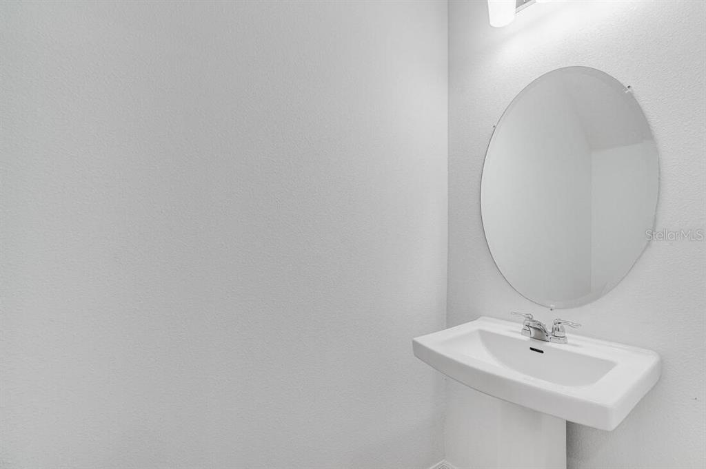 3035 Novara Lane Lakewood Ranch, FL 34211 - Photo 8 of 18 a bathroom with a sink and a mirror