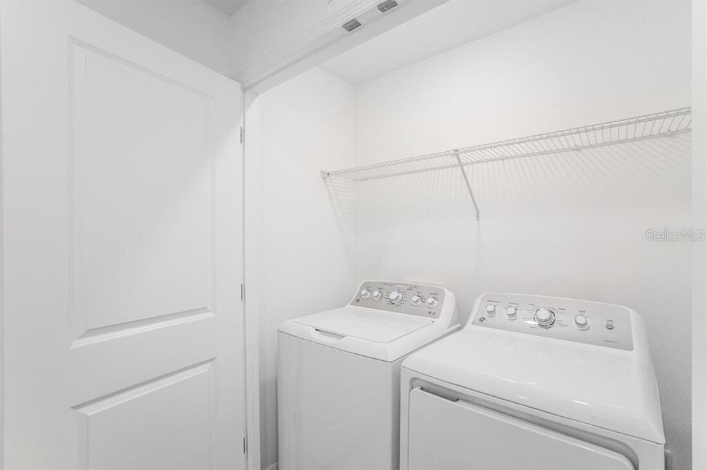3035 Novara Lane Lakewood Ranch, FL 34211 - Photo 10 of 18 a view of storage and utility room with washer and dryer