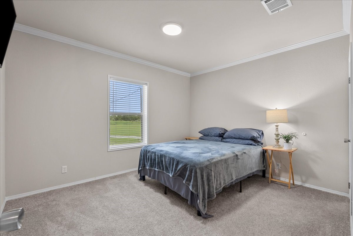 8710 Fm 646 Road South Santa Fe, TX 77510 - Photo 18 of 32 The third bedroom offers a lovely view of the backyard, creating a bright and peaceful space to enjoy