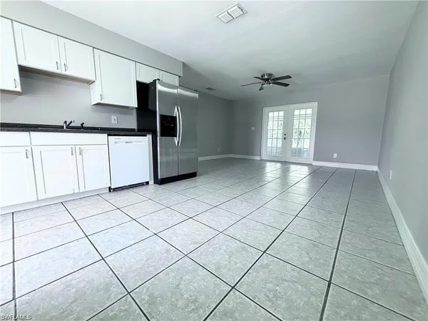 a kitchen with stainless steel appliances a sink a stove a microwave and cabinets