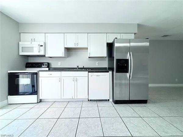 a kitchen with cabinets and steel stainless steel appliances