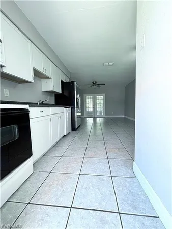 a kitchen with a sink a stove top oven and cabinets