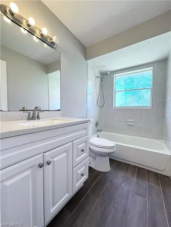 a bathroom with a toilet a sink and bathtub