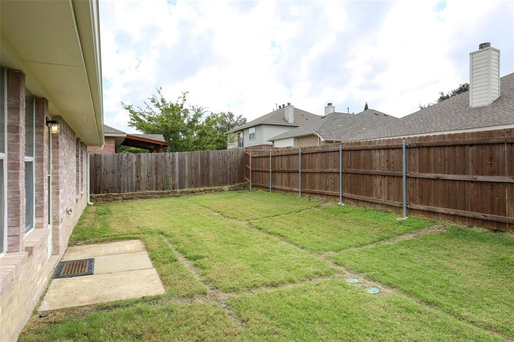 5961 Cheyenne Way Frisco, TX 75034 - Photo 29 of 33 Expansive grassy yard area featuring a full wood privacy fence and a concrete patio